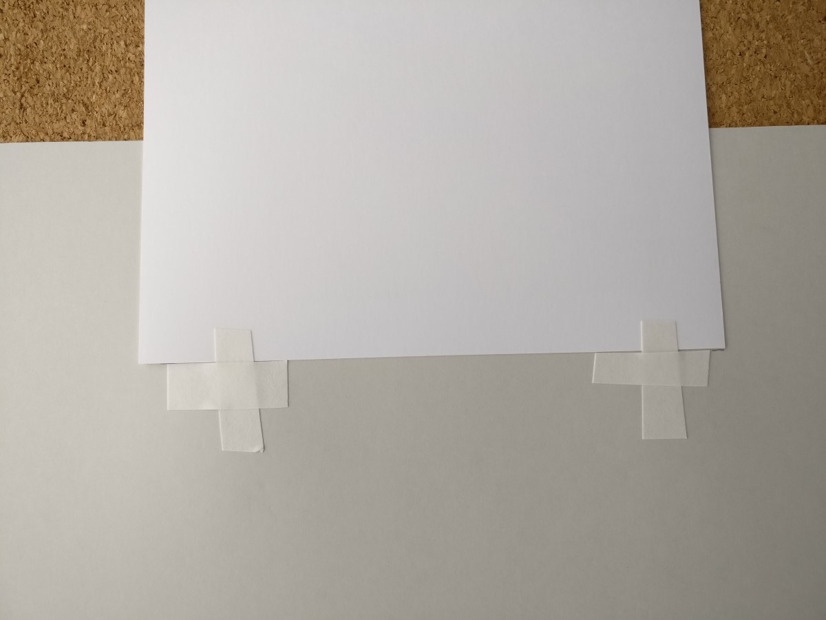 Apply two pieces of tape in each upper corner.